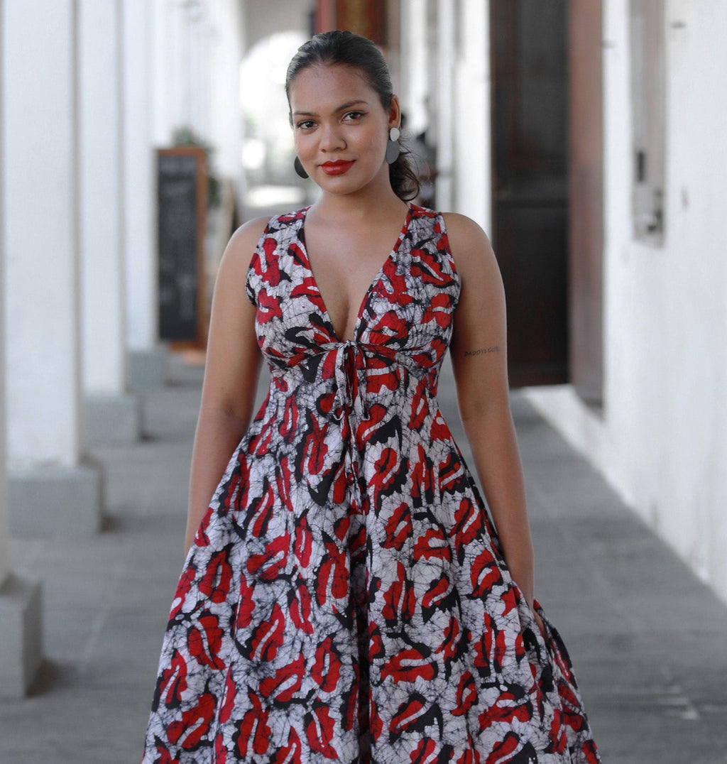 Woman in red and white Vanessa Butterfly Maxi Dress standing on a sidewalk.