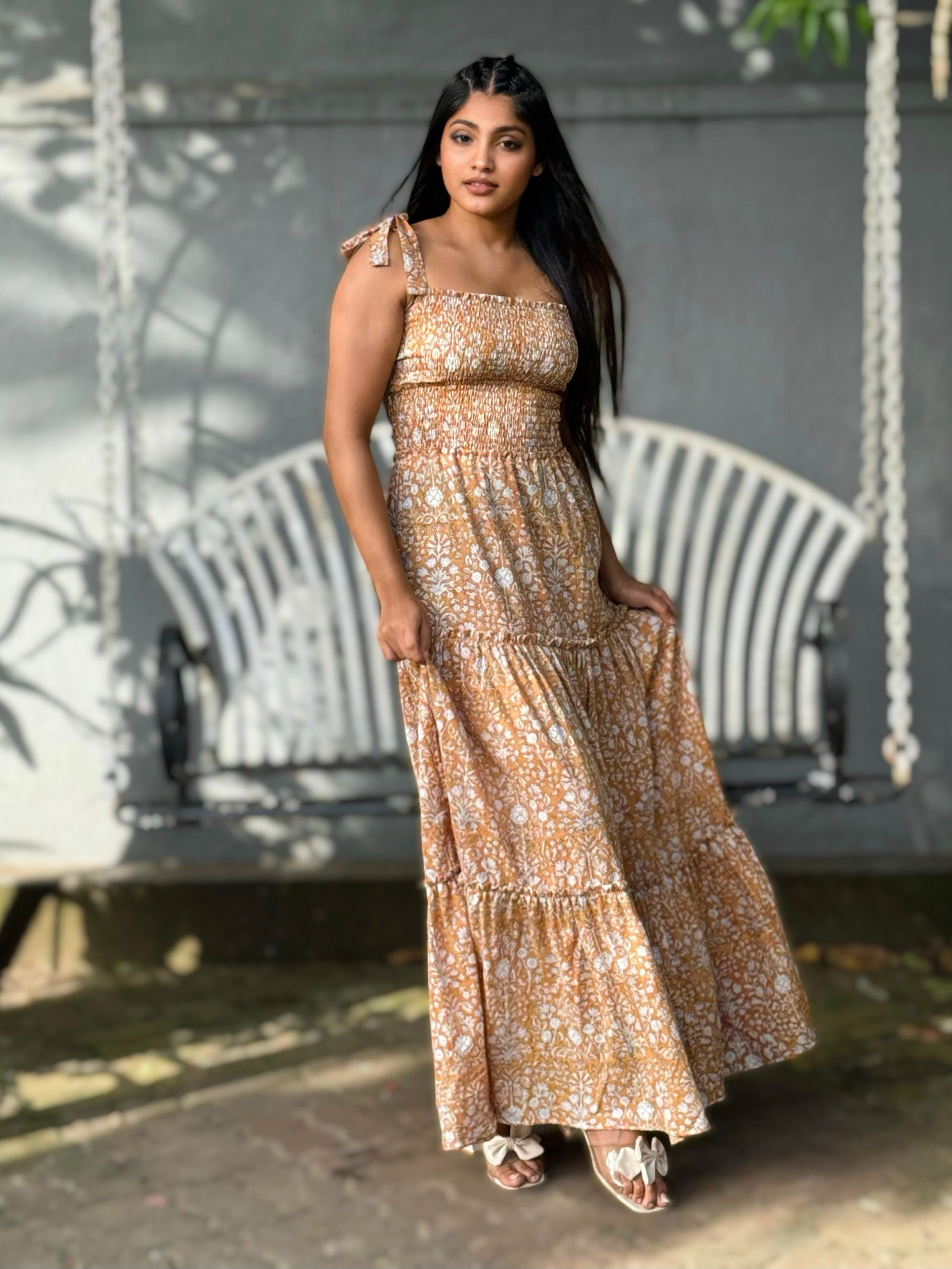 Woman in Hoya Tie-Straps Sun Dress standing in front of a swing