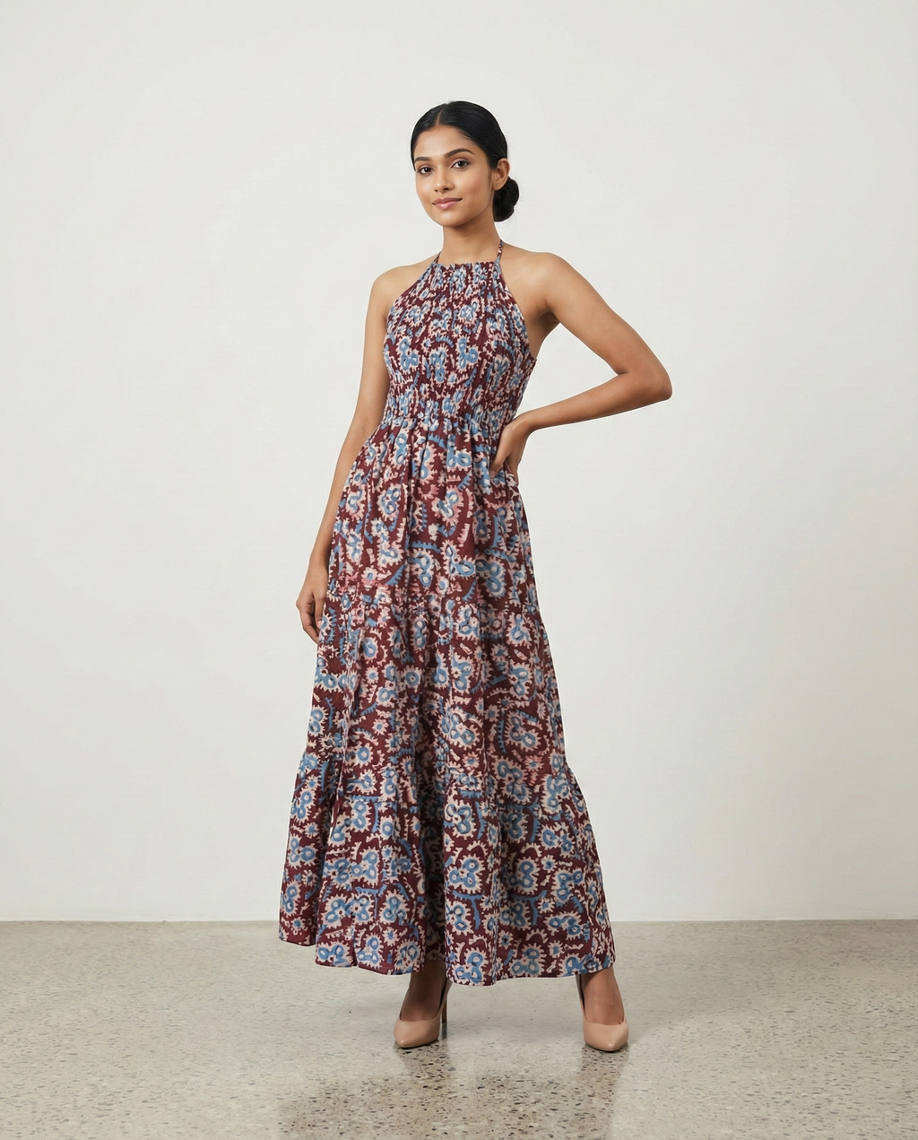Woman wearing a floral dress against a plain background